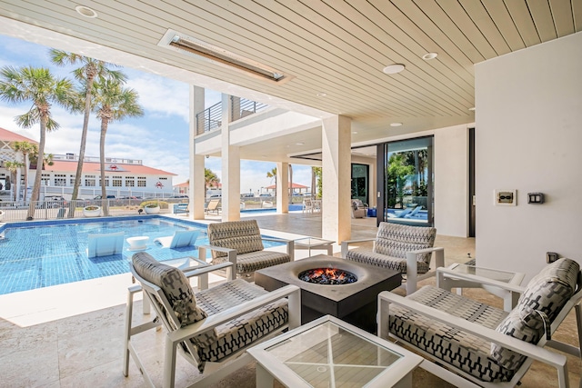 view of patio / terrace featuring a fire pit and a community pool