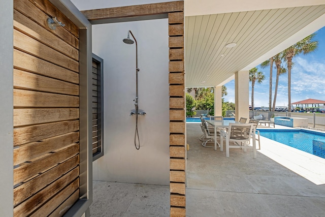 view of patio featuring outdoor dining space and a fenced in pool