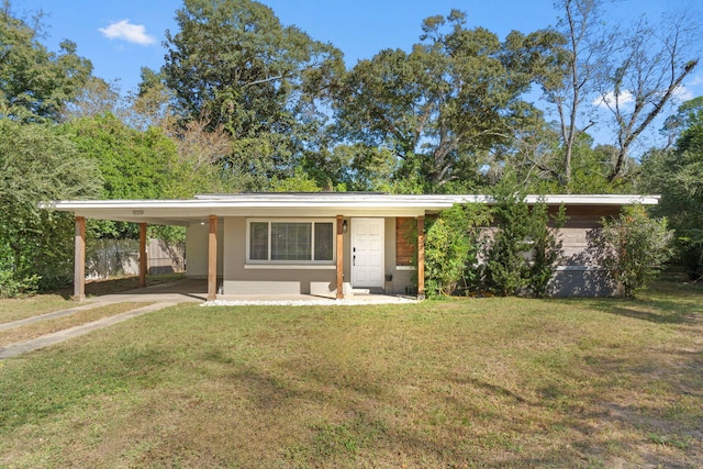 view of front facade with a front lawn and an attached carport