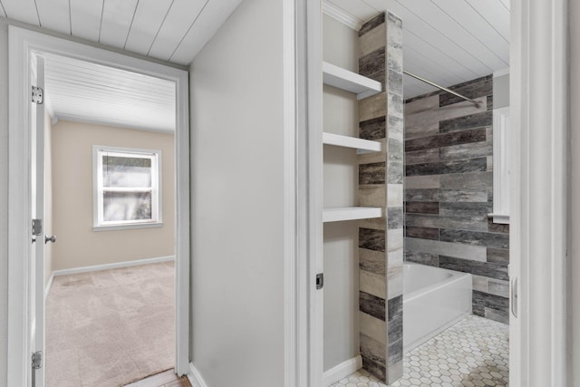 bathroom featuring a washtub, baseboards, and walk in shower