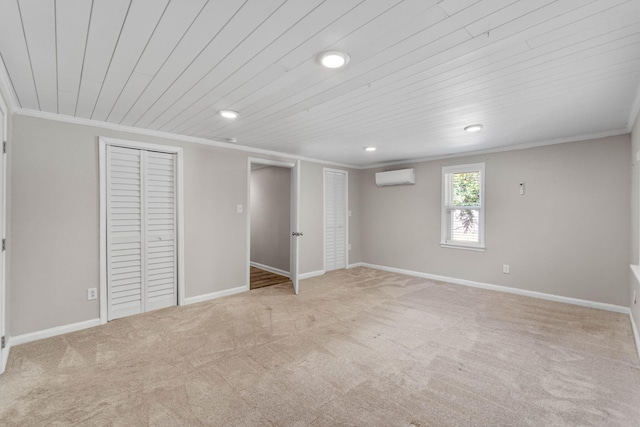 unfurnished bedroom with ornamental molding, carpet flooring, and a wall mounted AC