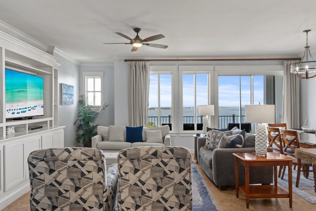 living room featuring crown molding, a water view, light tile patterned floors, and ceiling fan with notable chandelier