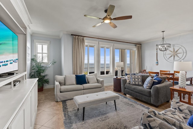 living room featuring a water view, baseboards, ornamental molding, and ceiling fan with notable chandelier