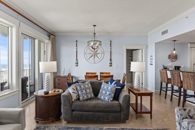 living area featuring crown molding, a notable chandelier, visible vents, and light tile patterned floors