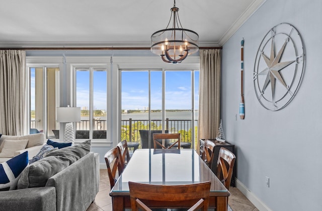 dining space featuring crown molding, a water view, an inviting chandelier, and a wealth of natural light