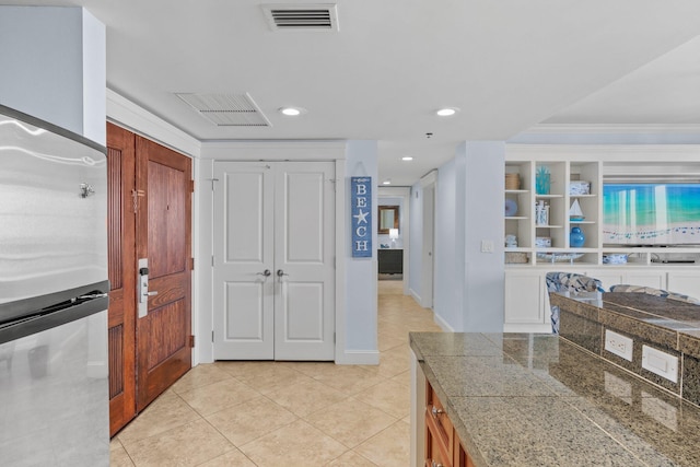 interior space with ornamental molding, recessed lighting, light tile patterned flooring, and visible vents