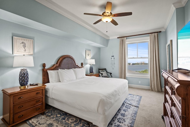 bedroom with crown molding, baseboards, multiple windows, and light carpet