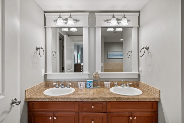 full bath featuring a sink and double vanity