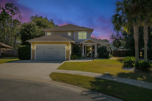 view of front of property with a garage, concrete driveway, a lawn, and fence