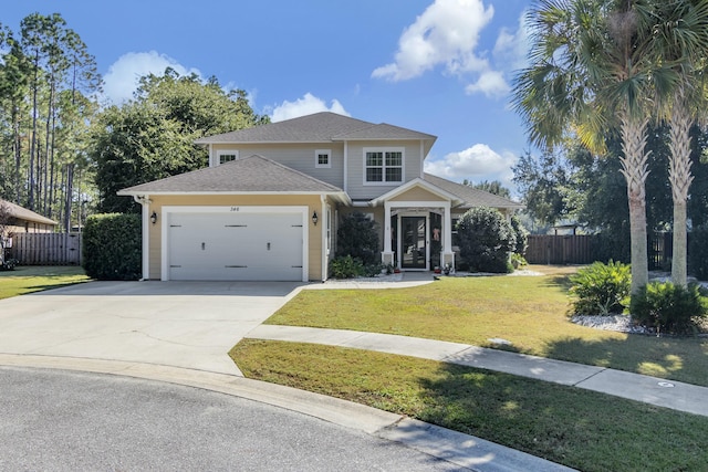 view of front of home featuring driveway, a front lawn, an attached garage, and fence