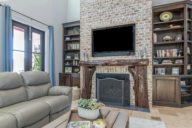 living room featuring stone finish flooring and a fireplace