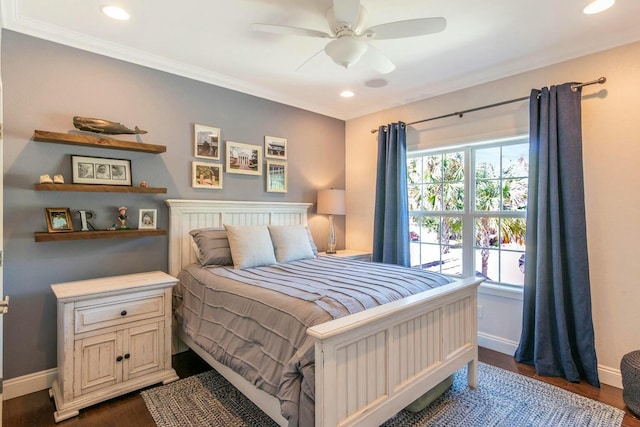 bedroom featuring crown molding, dark wood-style flooring, and baseboards