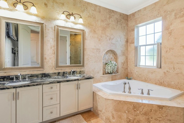 full bathroom with double vanity, ornamental molding, a sink, and a bath