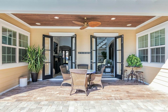 view of patio featuring outdoor dining area and a ceiling fan