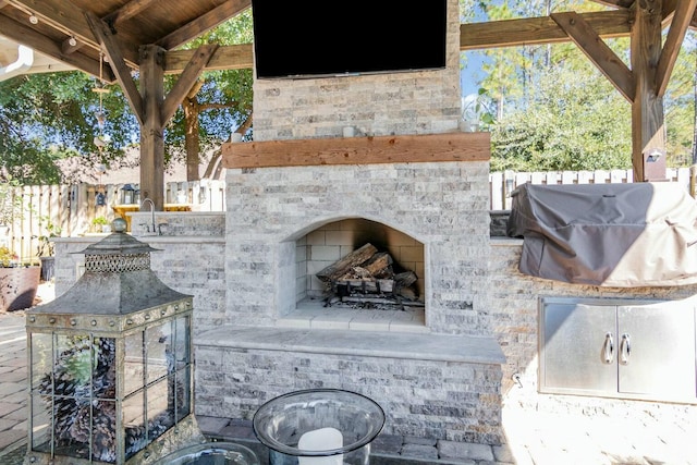 details with fence and an outdoor fireplace