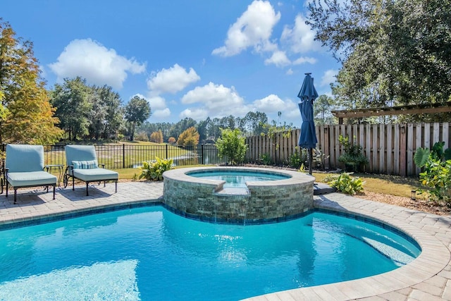 view of swimming pool with a patio area, a fenced backyard, and a pool with connected hot tub