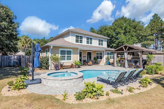 rear view of house featuring a fenced backyard, an in ground hot tub, a gazebo, a fenced in pool, and a patio area