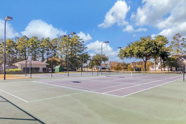 view of tennis court featuring fence