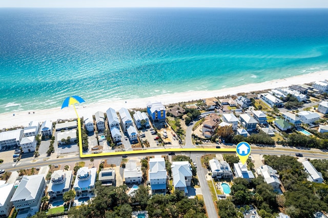 birds eye view of property featuring a beach view, a residential view, and a water view