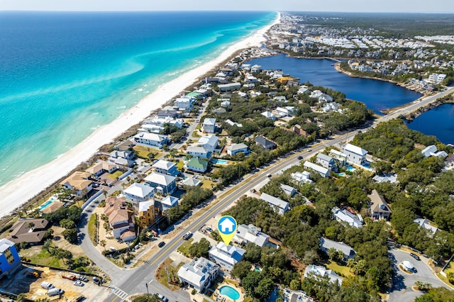 bird's eye view featuring a water view and a beach view