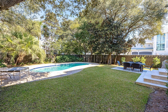 view of pool featuring a patio, a yard, a fenced backyard, and a fenced in pool