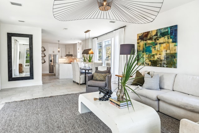 living area featuring visible vents and baseboards