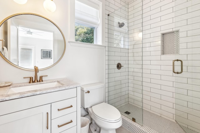 full bathroom with toilet, a shower stall, and vanity