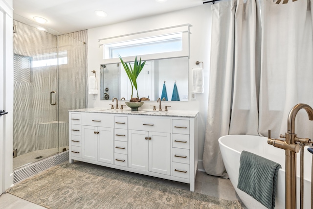 full bathroom with a sink, double vanity, tile patterned flooring, and a shower stall