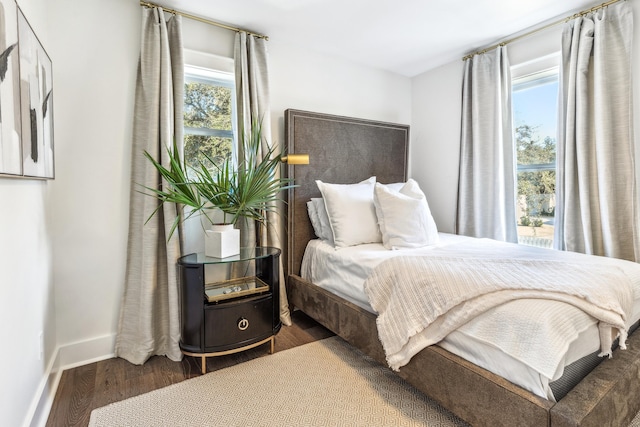 bedroom featuring wood finished floors and baseboards