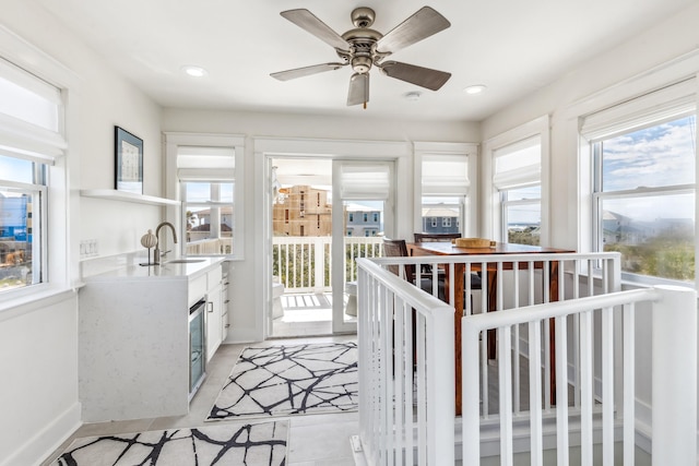 interior space featuring open shelves, recessed lighting, light countertops, white cabinets, and a sink