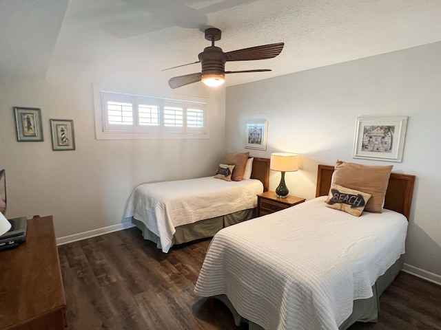 bedroom with ceiling fan, a textured ceiling, wood finished floors, and baseboards