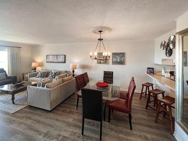 dining room with dark wood-style floors, a textured ceiling, baseboards, and an inviting chandelier