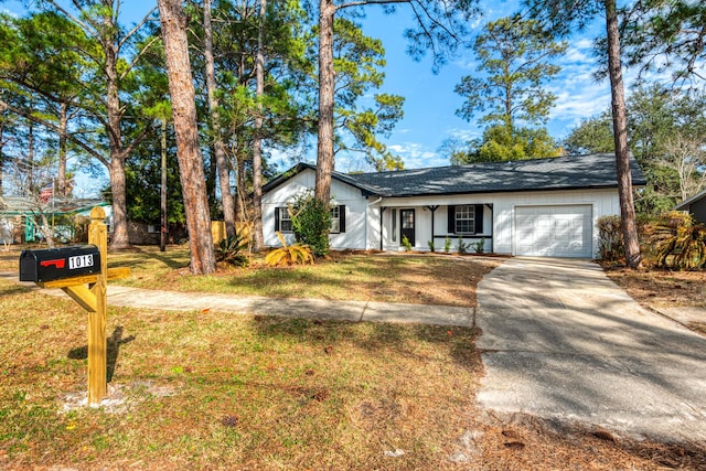 ranch-style home featuring a garage, driveway, and a front lawn