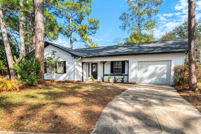 ranch-style house featuring a garage, concrete driveway, a porch, and board and batten siding