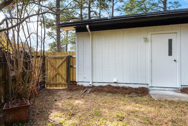 view of outdoor structure featuring a gate and fence