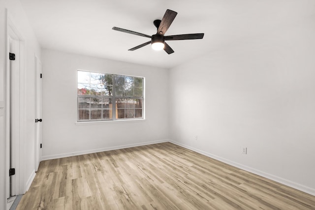 unfurnished bedroom featuring ceiling fan, light wood-style flooring, and baseboards