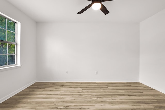 spare room with a ceiling fan, baseboards, and wood finished floors