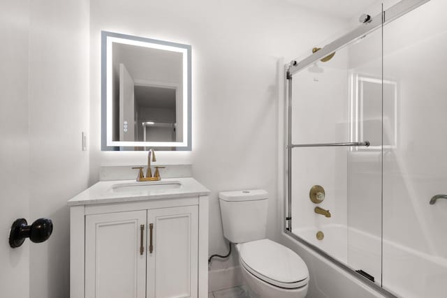 bathroom with toilet, combined bath / shower with glass door, and vanity