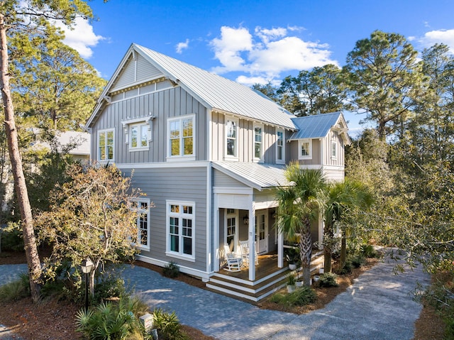 view of front of home featuring metal roof, a porch, and board and batten siding