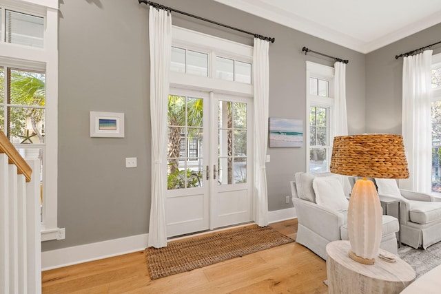 entryway featuring stairway, wood finished floors, a wealth of natural light, and baseboards