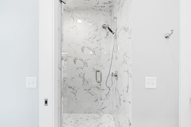 bathroom with a marble finish shower