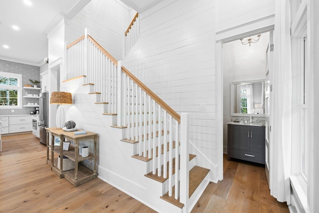 stairway featuring recessed lighting and hardwood / wood-style floors