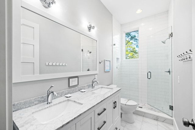 bathroom featuring a sink, a shower stall, toilet, and double vanity