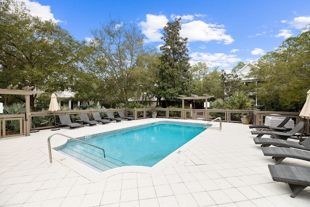 pool featuring a pergola and a patio