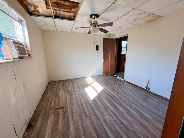 unfurnished room featuring cooling unit, ceiling fan, and wood finished floors