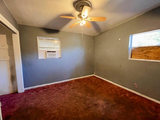 spare room with a ceiling fan, cooling unit, carpet flooring, and baseboards