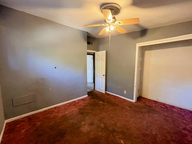 unfurnished bedroom featuring carpet floors, a ceiling fan, visible vents, and baseboards