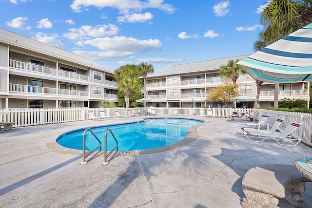 community pool featuring a patio area and fence