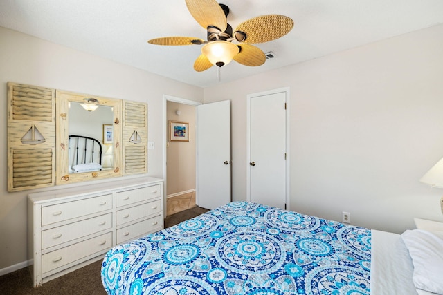 bedroom with dark colored carpet, visible vents, baseboards, and ceiling fan