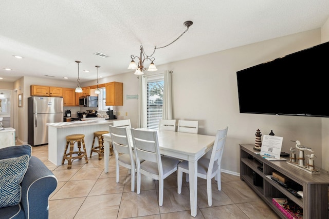 dining area with baseboards, visible vents, light tile patterned flooring, recessed lighting, and a textured ceiling